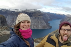 Selfie of Ellie Bloodworth and boyfriend Arron celebrating surviving a cold night camped on Norway's Trolltunga. 2018