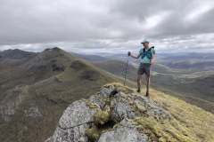May-Joe-Fisher-on-Aonach-Beag-with-the-Grey-Corries-behind-Photo-Ros-Murray